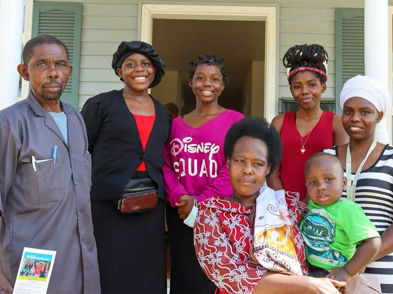 A family stands outside of a home