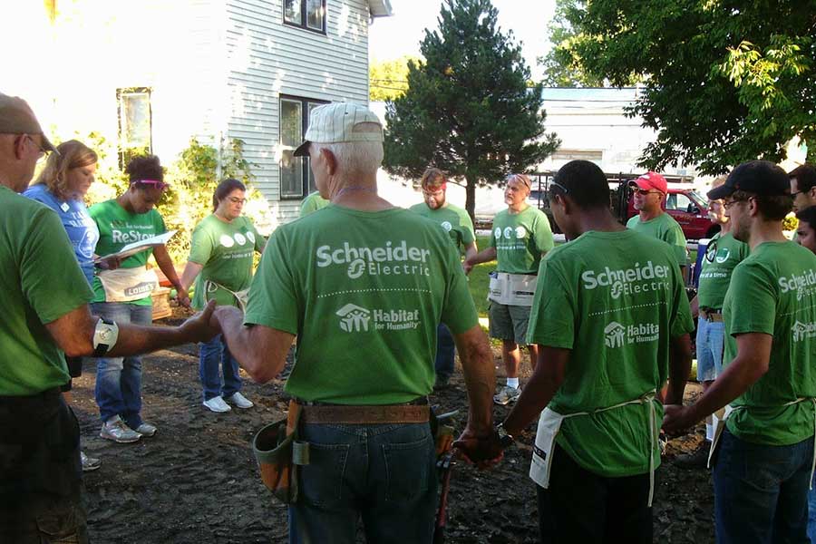 Volunteers from Schneider Electric and Habitat for Humanity gathered at a community project